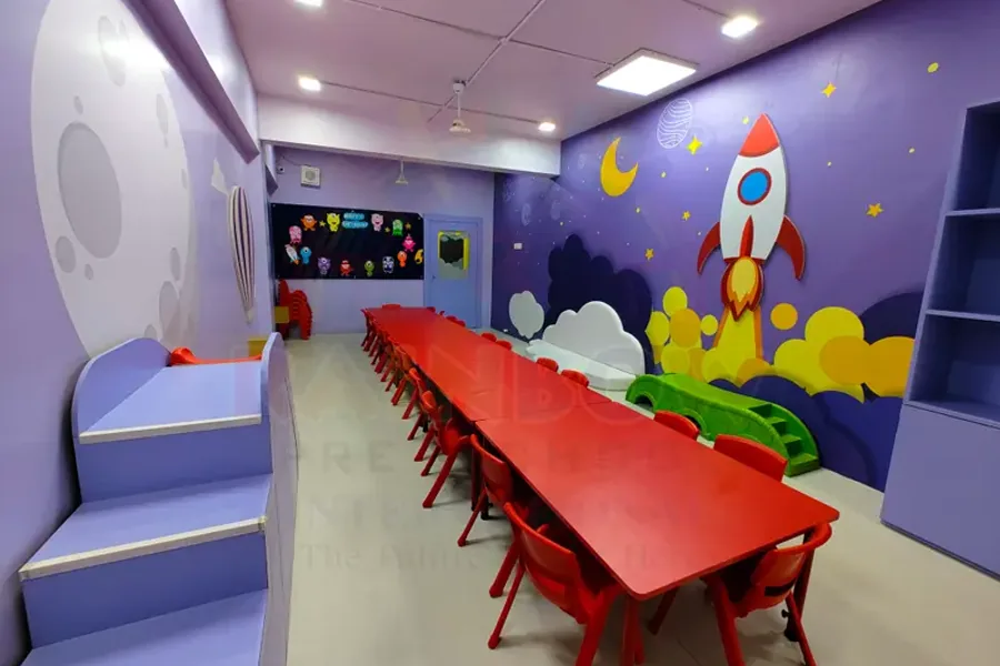 Bright preschool classroom with child-sized seating and a long activity table