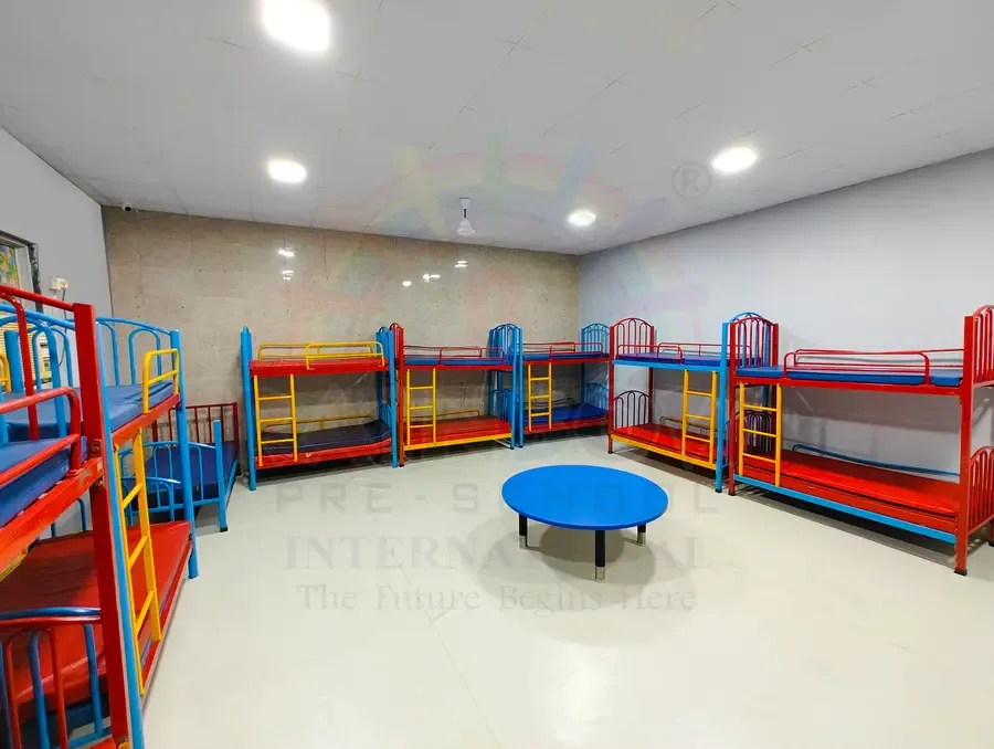 Daycare rest area with child-sized beds and colourful storage shelves