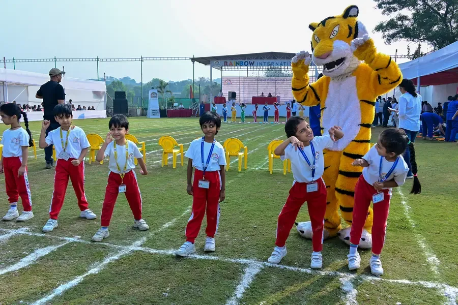 Children playing on a field during preschool sports day