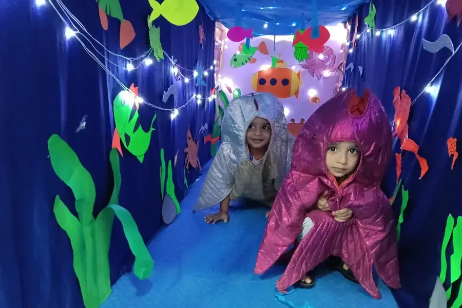 Children in colourful costumes during an under-the-sea themed preschool activity